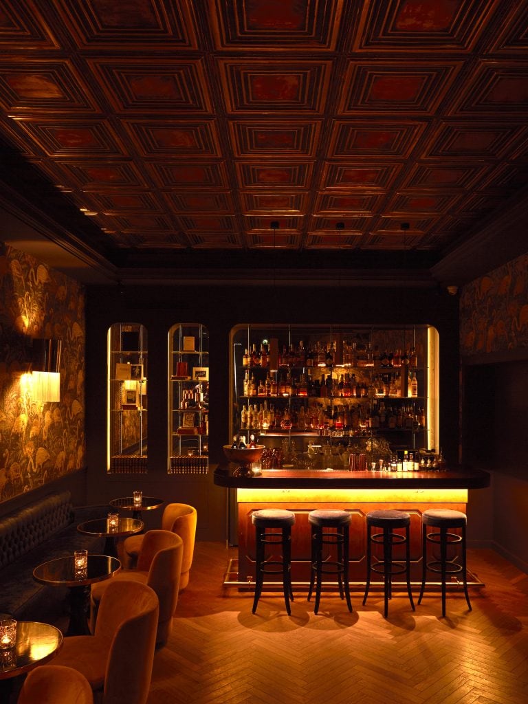 Inside of Fitzgerald Speakeasy in Paris. Dark room with old fashioned ambience