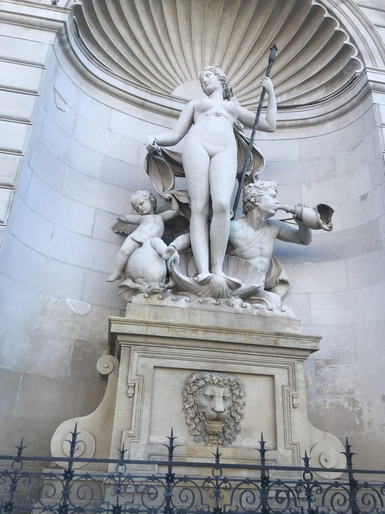 A huge white statue in Trieste, Italy of a nude woman from mythology, evoking the sea.