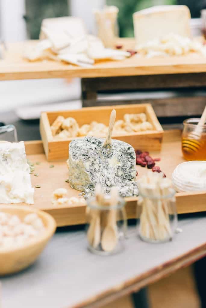 Variety of cheeses on a wooden platter, traditional french cheese.
